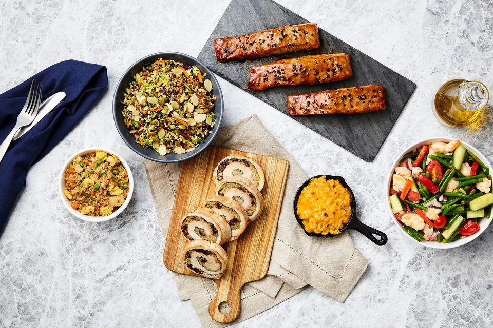 A spread of savoury dishes and colourful salads on a table